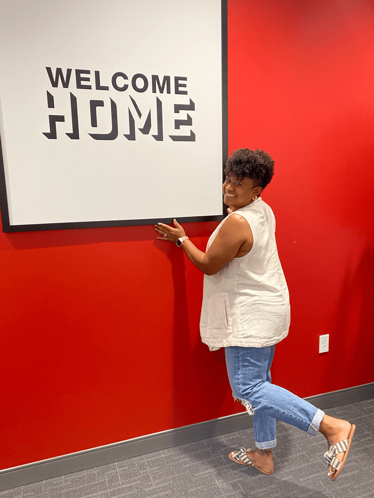 A happy client at the WELCOME HOME wall