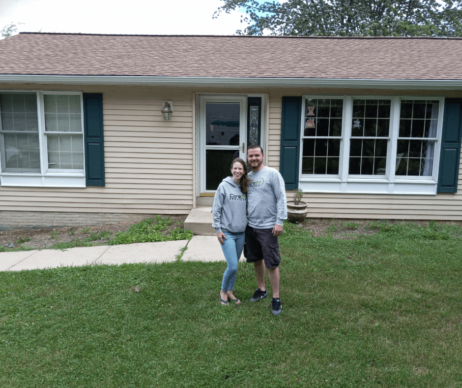 Happy clients in front of their new home